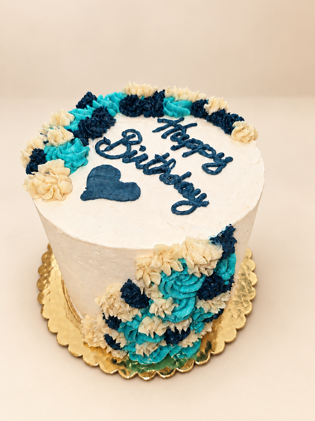 Vanessa’s birthday cake with turquoise, navy, and ivory buttercream flowers