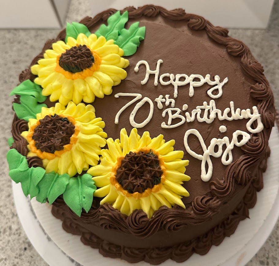 Chocolate cake with yellow buttercream sunflowers and birthday lettering